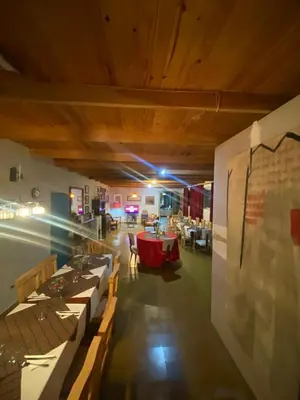 a group of tables in a room with a dining room at Posada Tanti El Durazno in Tanti