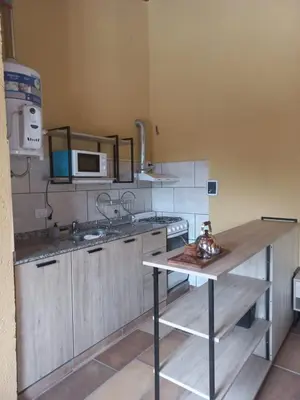 a kitchen with a sink and a counter top at Complejo Los Manantiales in Alta Gracia