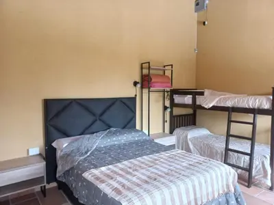 a room with two bunk beds and a bed at Complejo Los Manantiales in Alta Gracia