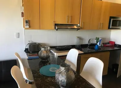 a kitchen with a table with chairs and a counter top at Villa General Belgrano - Puerto del Águila in Potrero de Garay