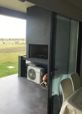 a living room with a microwave and a heater at Villa General Belgrano - Puerto del Águila in Potrero de Garay