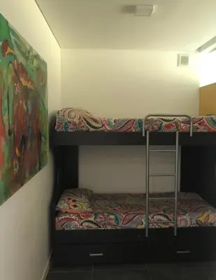 two bunk beds in a room with a painting at Villa General Belgrano - Puerto del Águila in Potrero de Garay