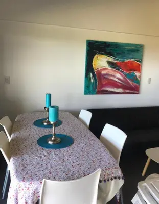 a dining room table with two blue candles on it at Villa General Belgrano - Puerto del Águila in Potrero de Garay