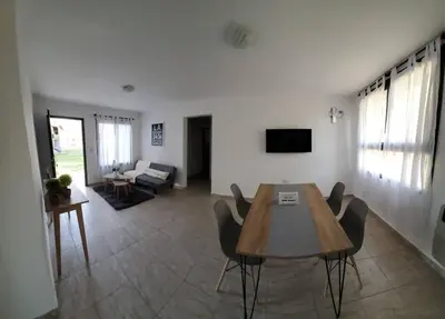 a living room with a wooden table and chairs at Complejo Dos Osos in Villa General Belgrano