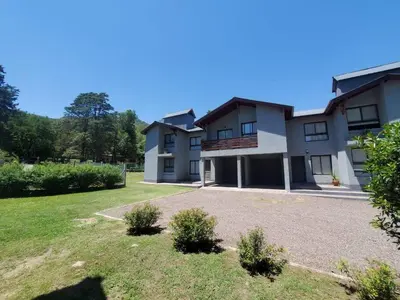 a large house with a yard in front of it at Complejo Dos Osos in Villa General Belgrano