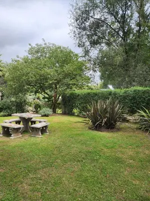 a picnic table in the grass in a park at Complejo Dos Osos in Villa General Belgrano