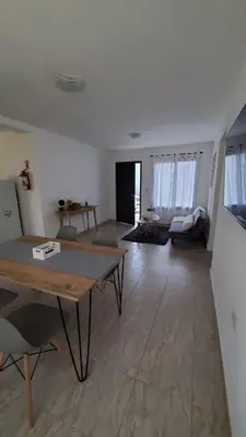 a living room with a table and a couch at Complejo Dos Osos in Villa General Belgrano