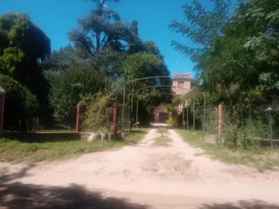 a dirt road with trees on the side of a road at Cabaña en quinta la aurora in Mina Clavero