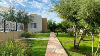 a walkway leading to a house in a yard at Morada del Cóndor - Cabañas Serranas in Merlo