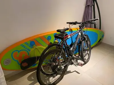 a bicycle is parked next to a surfboard at Casa frente al lago en barrio privado in Almafuerte