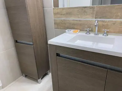 a bathroom with a sink and a mirror at Casa frente al lago en barrio privado in Almafuerte