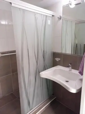 a bathroom with a sink and a shower curtain at Apartamento Faro de General Paz in Cordoba