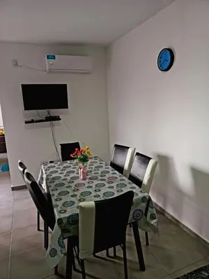 a dining room with a table with chairs and a tv at Apartamento Faro de General Paz in Cordoba