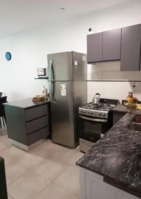 a kitchen with a stainless steel refrigerator and a stove at Apartamento Faro de General Paz in Cordoba