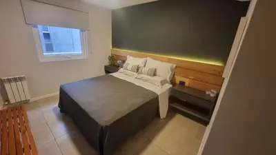 a small bedroom with a bed and a window at PISO TRES. Depto de categoría en cofico. C/Cochera in Cordoba