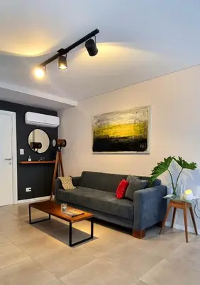 a living room with a couch and a table at PISO TRES. Depto de categoría en cofico. C/Cochera in Cordoba