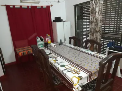 a table in a room with a red curtain at ESTANCIA VIEJA (CARLOS PAZ) in Estancia Vieja