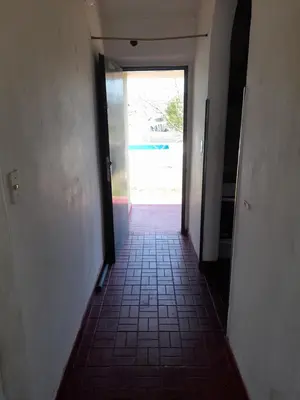a hallway with a door leading into a room at ESTANCIA VIEJA (CARLOS PAZ) in Estancia Vieja