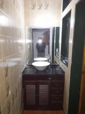 a person taking a picture of a bathroom with a sink at ESTANCIA VIEJA (CARLOS PAZ) in Estancia Vieja