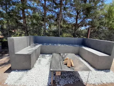 a concrete patio with a bench and a table at La Lola in Villa del Dique