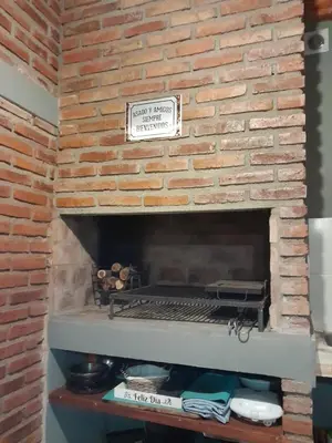 a brick fireplace with a grill on top of it at La Lola in Villa del Dique