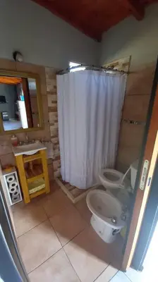 a bathroom with a shower and a toilet and a sink at La Lola in Villa del Dique