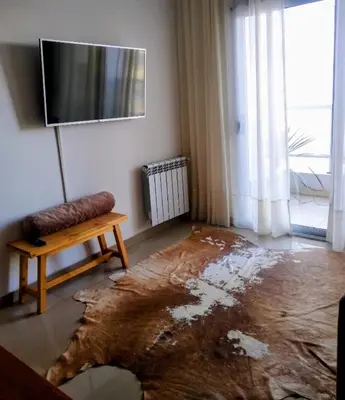 a room with a damaged floor with a table and a tv at Departamento a estrenar con piscina con cochera opcional in Río Cuarto