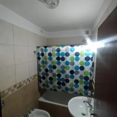 a bathroom with a sink and a shower curtain at Departamento zona Nuevocentro Shopping in Cordoba