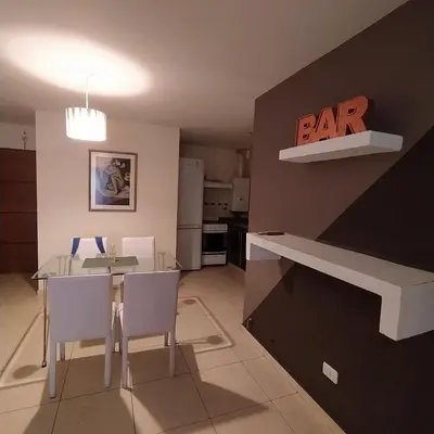 a kitchen and dining room with a table and chairs at Departamento zona Nuevocentro Shopping in Cordoba