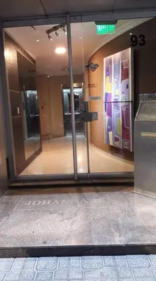 an entrance to a building with a glass door at Departamento zona Nuevocentro Shopping in Cordoba