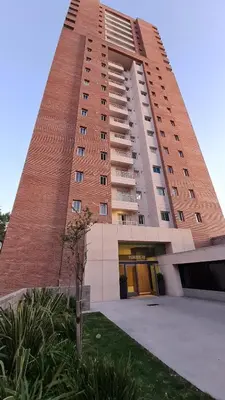 a tall brick building with a building at Confort Río Cuarto I in Río Cuarto