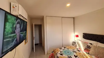 a bedroom with a bed and a flat screen tv at Confort Río Cuarto I in Río Cuarto