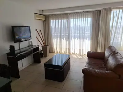 a living room with a couch and a television at Coral State Loft in Tower in Cordoba