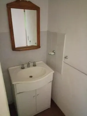 a bathroom with a white sink and a mirror at Lo de Juan Cabañas in Los Reartes