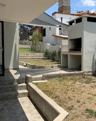a house with stairs leading into a yard at Casa de Ali in Villa Carlos Paz