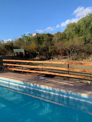 a wooden fence next to a pool of water at Malenka in Pantanillo