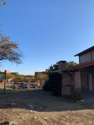 a house with a yard next to a building at Malenka in Pantanillo