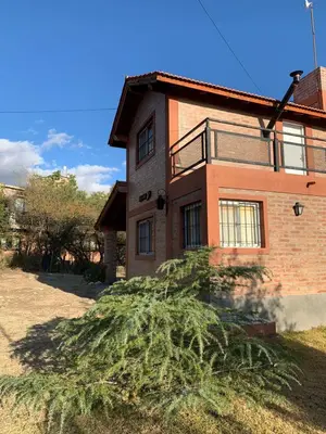 a tree in front of a brick house at Malenka in Pantanillo