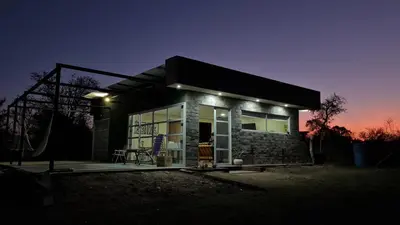 a small house with lights on it at night at Aromas serranos in Villa Rumipal