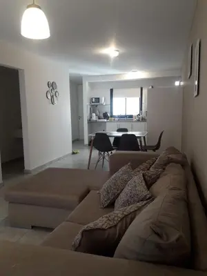 a living room with a couch and a dining room at Depto amoblado en el centro de la capital de cordoba in Cordoba
