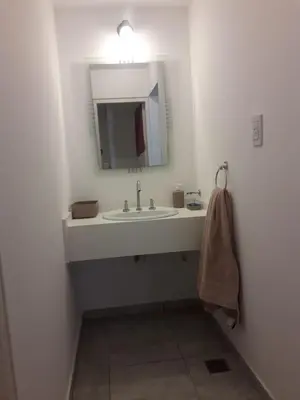 a bathroom with a sink and a mirror at Depto amoblado en el centro de la capital de cordoba in Cordoba