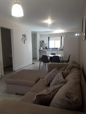 a living room with a couch and a dining room at Depto amoblado en el centro de la capital de cordoba in Cordoba