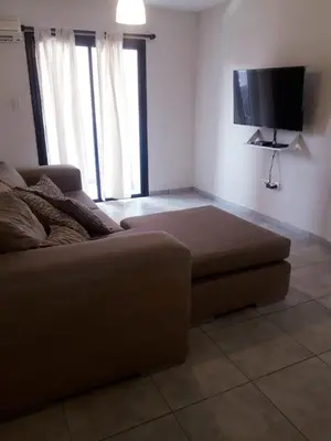 a living room with a couch and a flat screen tv at Depto amoblado en el centro de la capital de cordoba in Cordoba