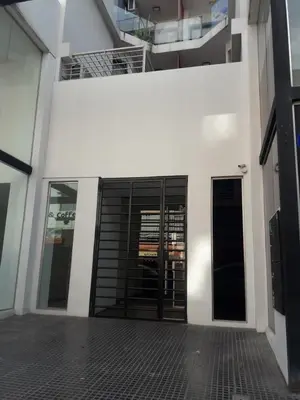 a white building with black doors on it at Depto amoblado en el centro de la capital de cordoba in Cordoba