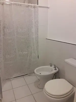 a bathroom with a toilet and a shower curtain at Depto amoblado en el centro de la capital de cordoba in Cordoba