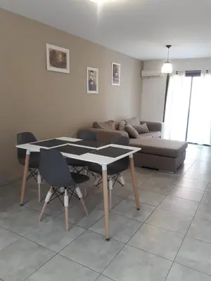 a living room with a table and a couch at Depto amoblado en el centro de la capital de cordoba in Cordoba
