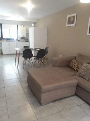 a living room with a couch and a table with chairs at Depto amoblado en el centro de la capital de cordoba in Cordoba