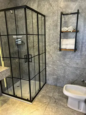 a shower stall in a bathroom with a toilet at Dinastie Country in Villa Rumipal