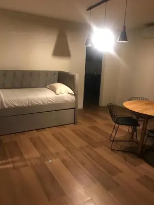 a room with a bed and a table and a table and chair at Dinastie Country in Villa Rumipal