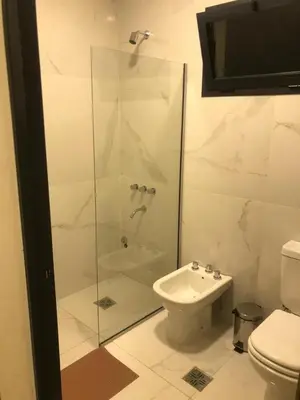 a bathroom with a shower and a toilet and a sink at Dinastie Country in Villa Rumipal